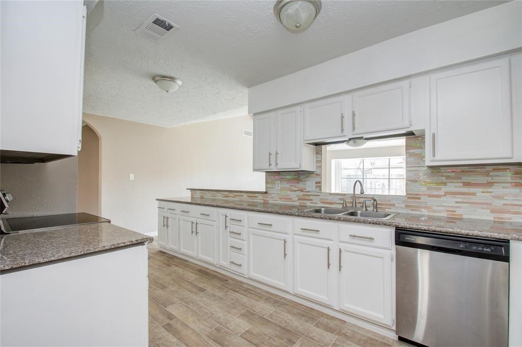 10510 Rancho Bernardo Lane Sugar Land, TX 77498 - Photo 10 of 27 a kitchen with granite countertop white cabinets and a sink