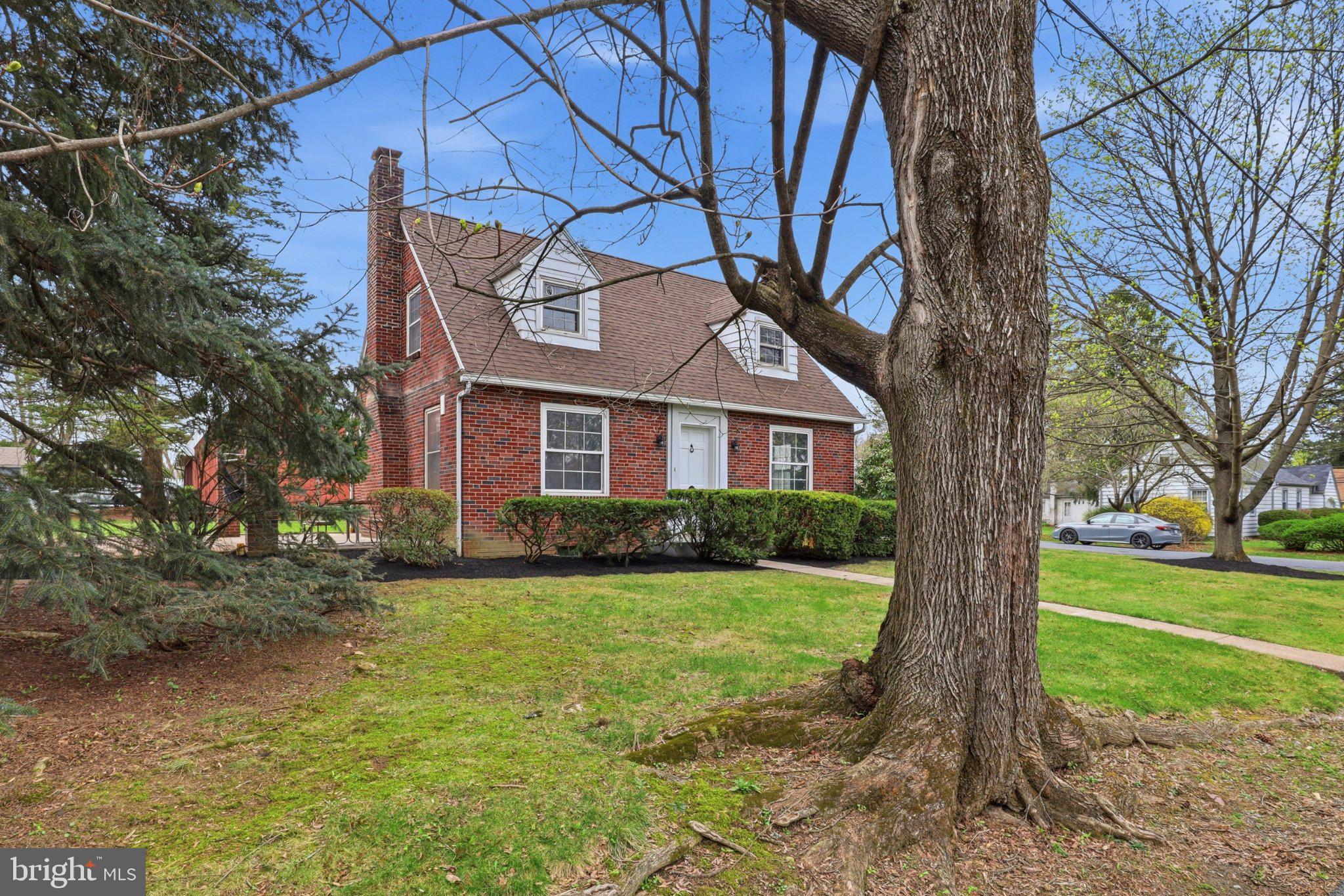 120 Maple Road Harrisburg, PA 17109 - Photo 4 of 53 Charming brick home with lush greenery.