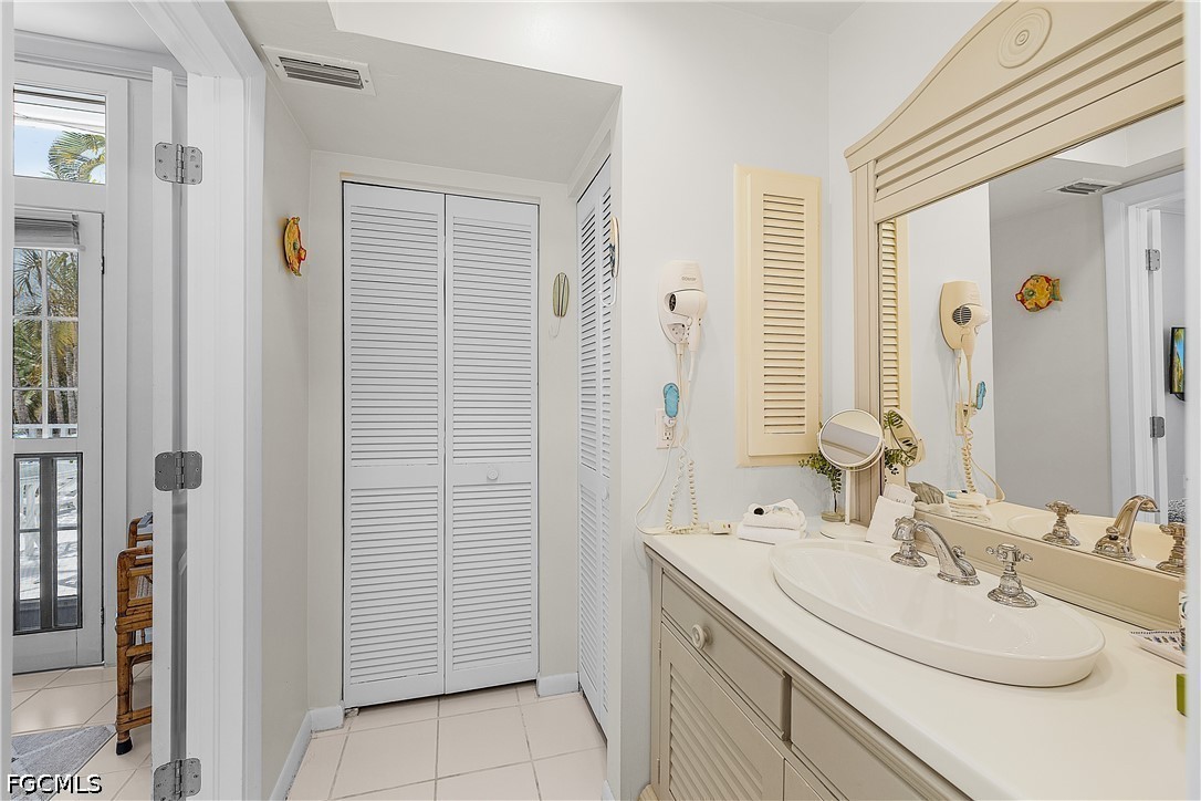 515 Useppa Useppa Island Bokeelia, FL 33922 - Photo 25 of 43 a bathroom with a double vanity sink and a mirror