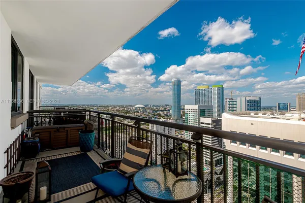 a view of a balcony with furniture