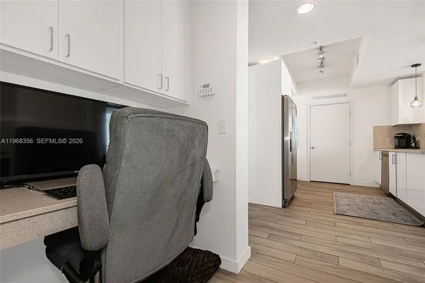 a view of kitchen with stainless steel appliances refrigerator and microwave