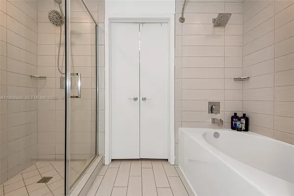 a bathroom with a bathtub and shower
