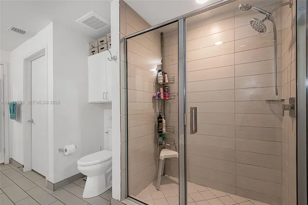 a bathroom with a shower and a toilet