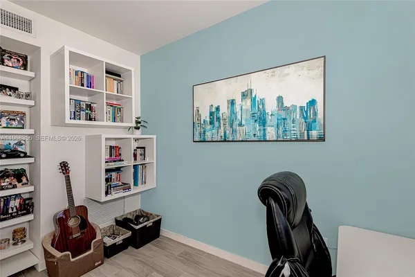 a view of a workspace with furniture and closet