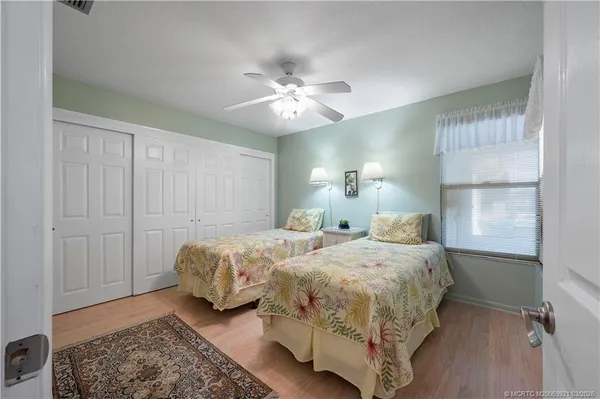 a bedroom with two beds and a chandelier