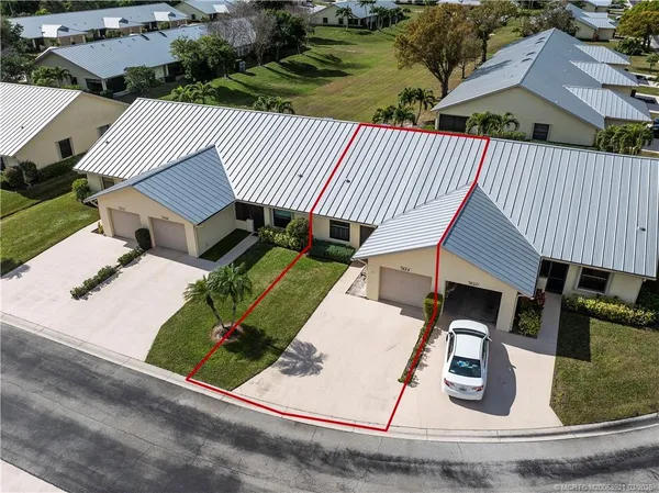 an aerial view of a house with garden space and street view