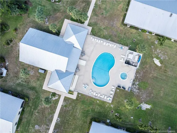 an aerial view of a house roof deck and chairs