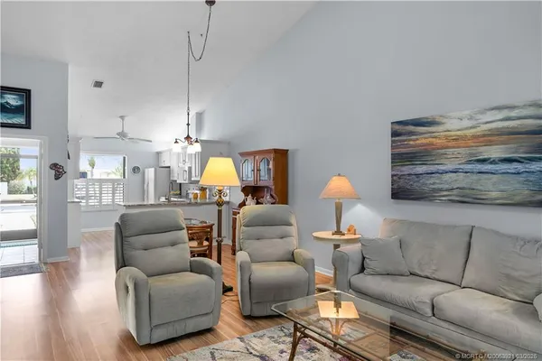 a living room with furniture and a lamp