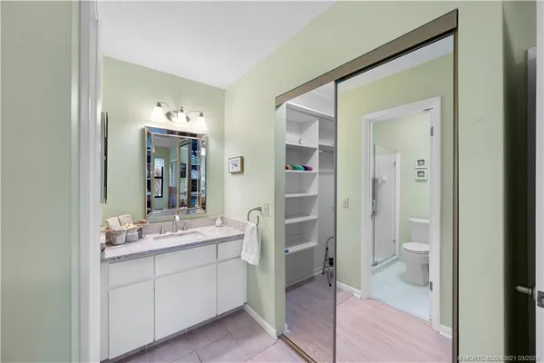 a en suite bathroom with a granite countertop sink toilet and shower