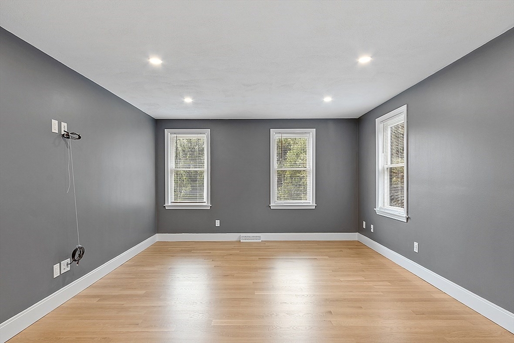 22 Coleman Road Groveland, MA 01834 - Photo 18 of 35 an empty room with wooden floor and windows