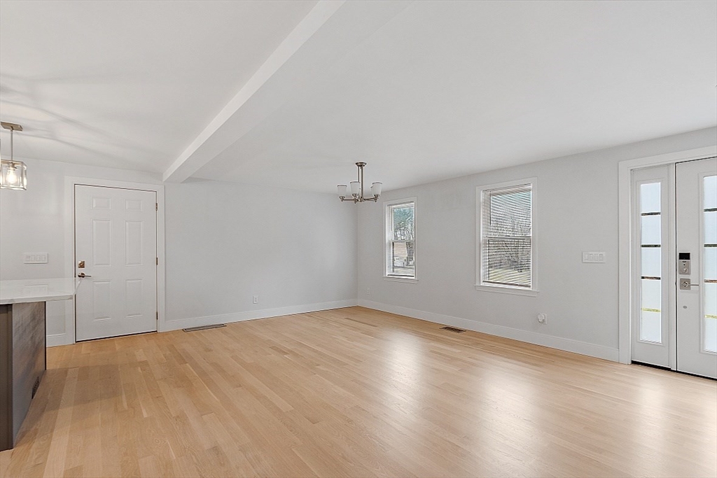22 Coleman Road Groveland, MA 01834 - Photo 8 of 35 an empty room with wooden floor and windows