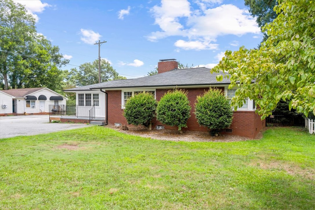 212 East Shockley Ferry Road Anderson, SC 29624 - Photo 3 of 28 A classic brick facade with mature landscaping offers inviting curb appeal.