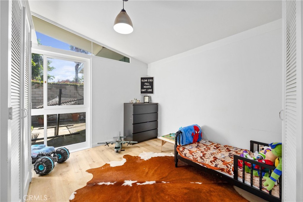 13062 Chaplet Place Tustin, CA 92780 - Photo 17 of 27 a bedroom with furniture and a book shelf