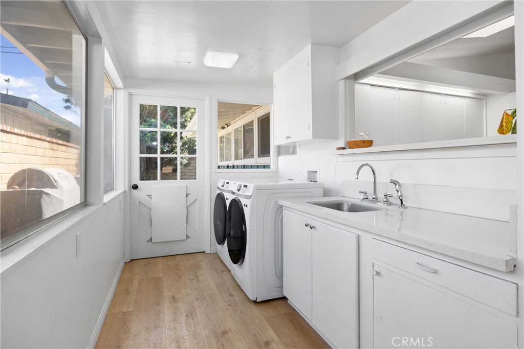 13062 Chaplet Place Tustin, CA 92780 - Photo 20 of 27 a utility room with sink dryer and washer