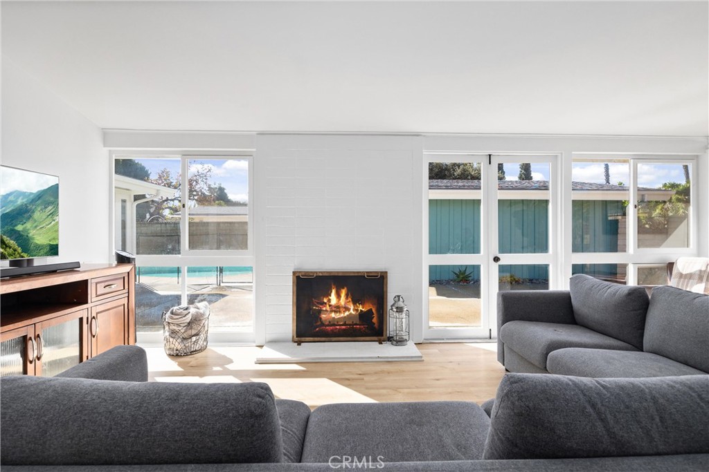 13062 Chaplet Place Tustin, CA 92780 - Photo 8 of 27 a living room with furniture a fireplace and a large window