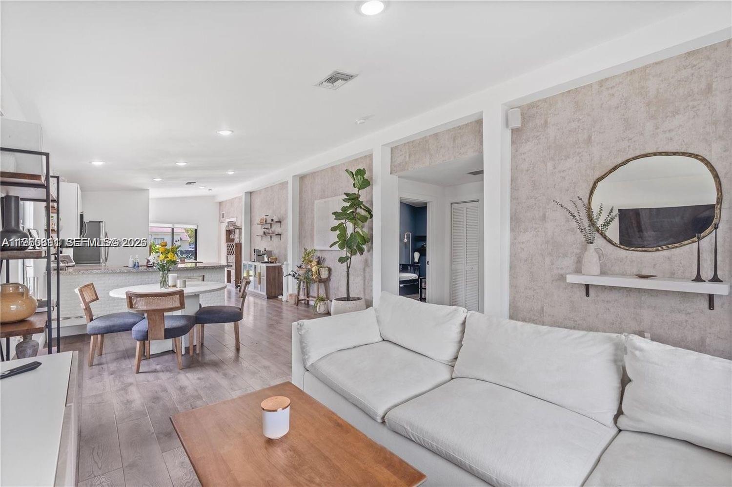 944 Northwest 64th Street Miami, FL 33150 - Photo 4 of 19 a living room with furniture and view of kitchen