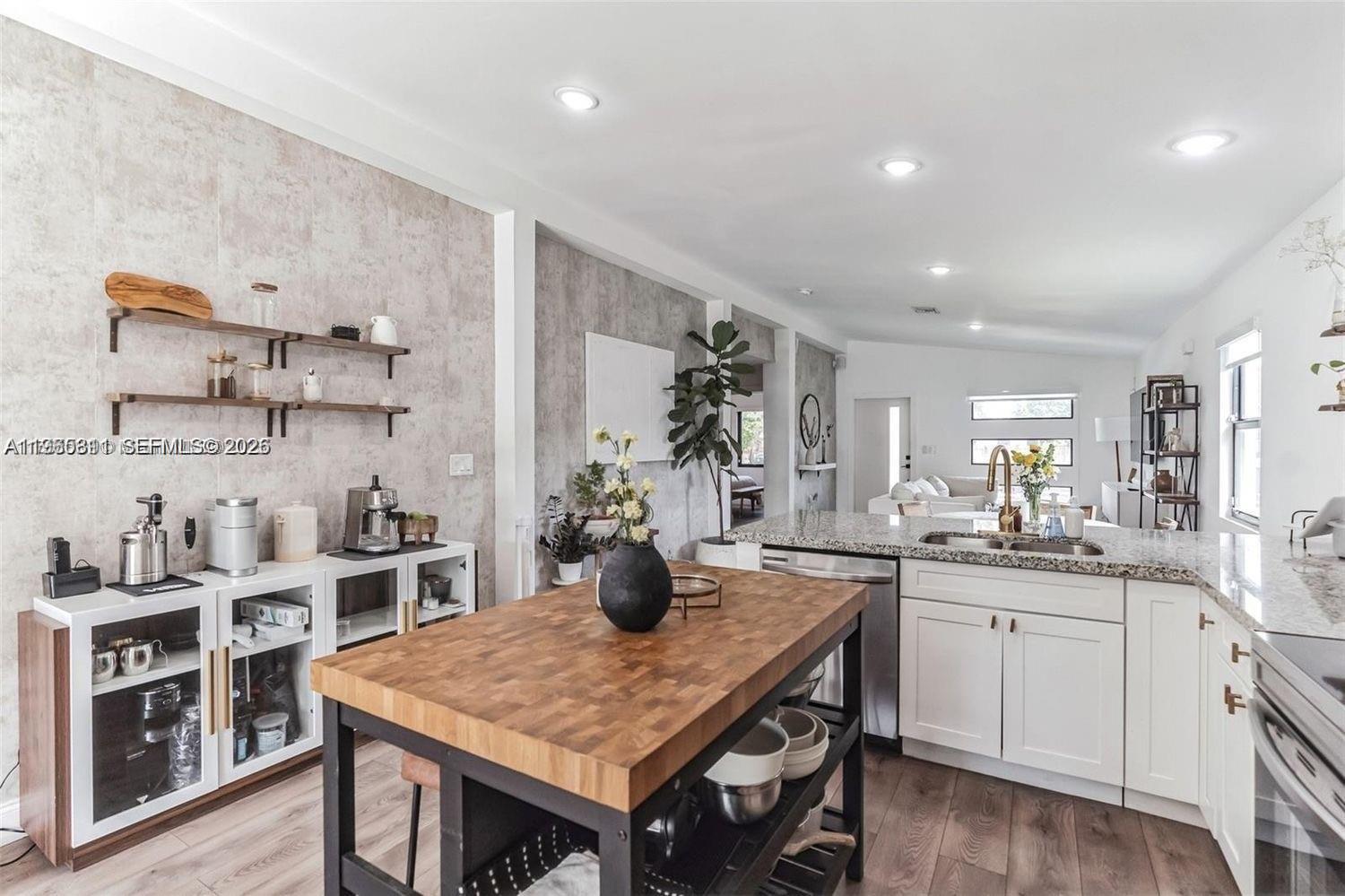 944 Northwest 64th Street Miami, FL 33150 - Photo 7 of 19 a kitchen with cabinets appliances and furniture
