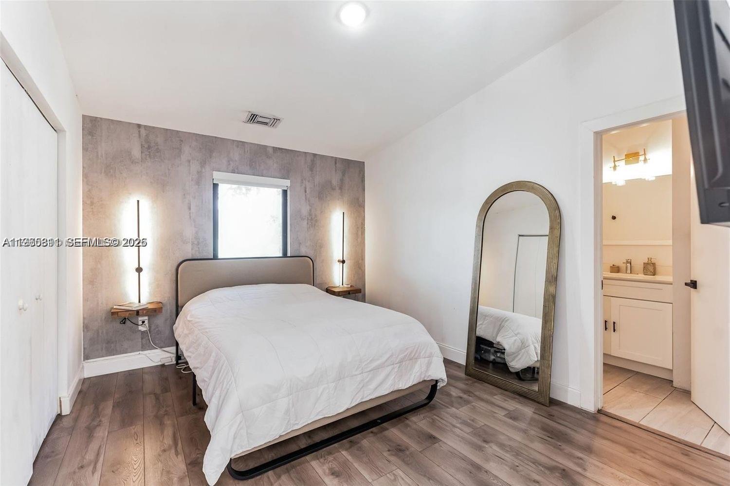 944 Northwest 64th Street Miami, FL 33150 - Photo 10 of 19 a bedroom with a bed and a potted plant