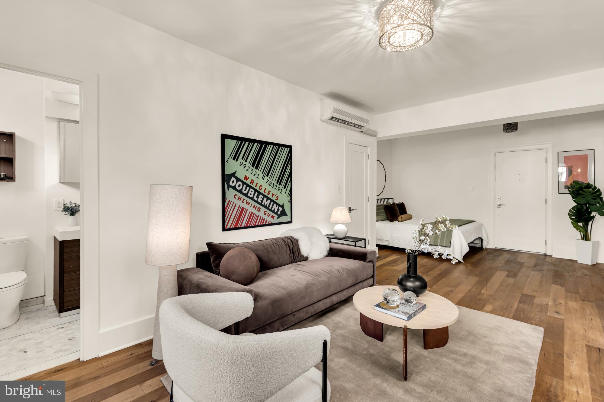 1910 Kalorama Road Northwest, Unit 302 Washington, DC 20009 - Photo 4 of 28 a living room with furniture and a wooden floor