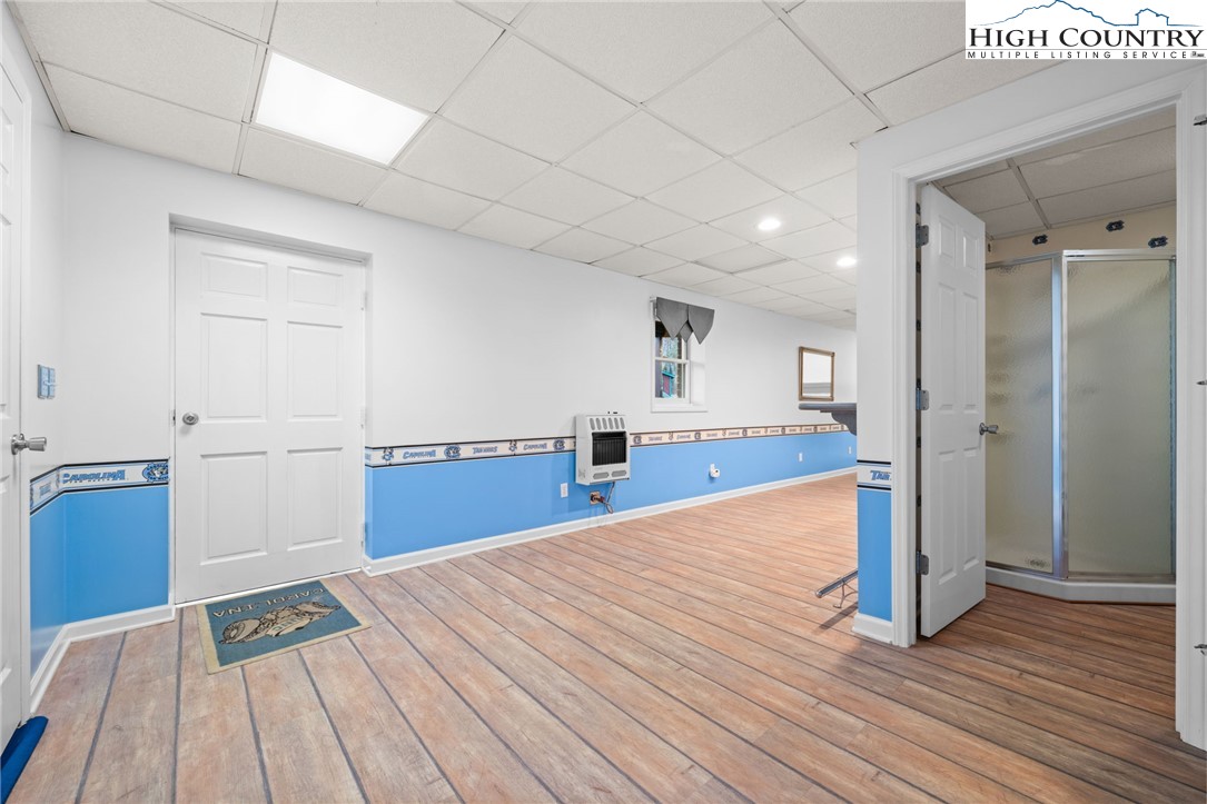 458 Jim Caudill Road Wilkesboro, NC 28697 - Photo 32 of 50 a bedroom with a bed and wooden floor