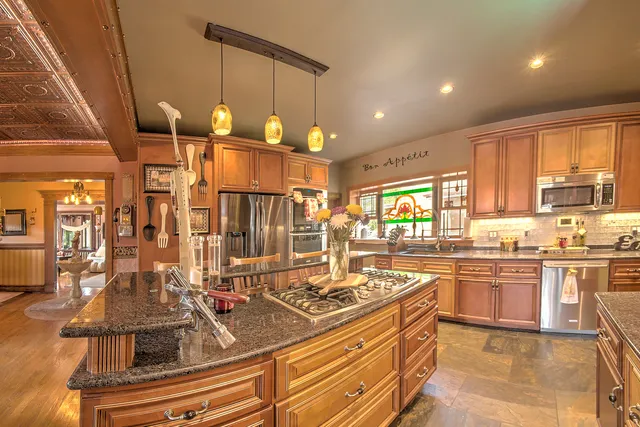a view of a dining room with furniture a chandelier and wooden floor