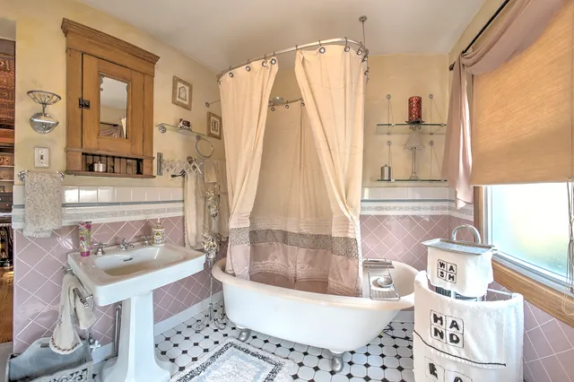 a living room with furniture a rug and a floor to ceiling window