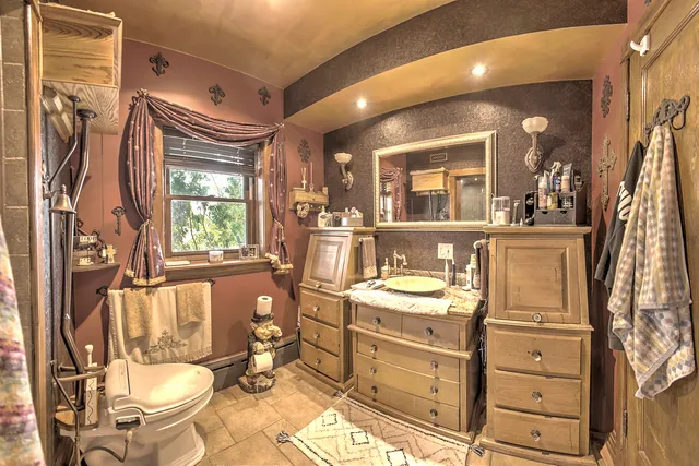 a bathroom with a toilet shower and a sink