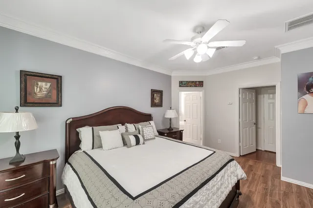 a bedroom with a bed and a lamp on table