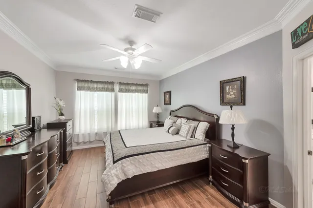 a bedroom with a bed and a chandelier