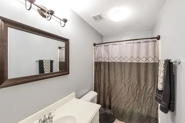 a bathroom with a toilet and shower