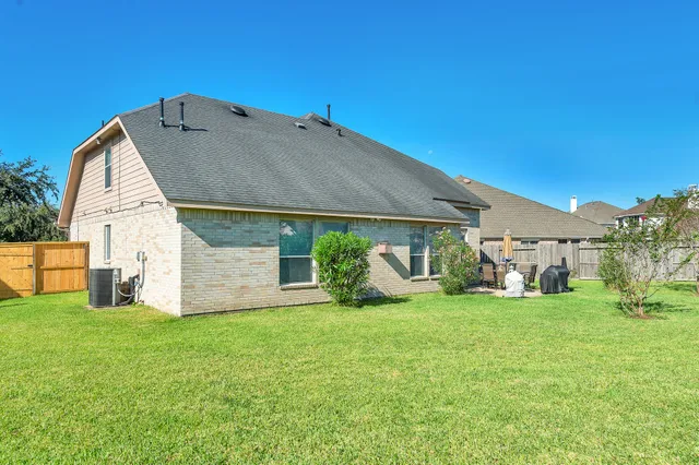 a view of a house with a yard and sitting area