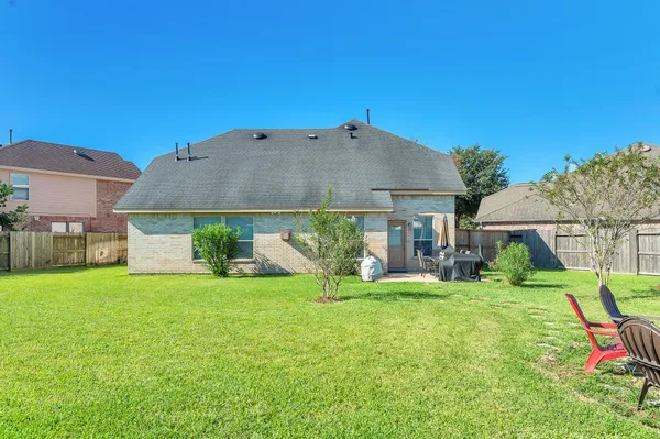 a view of a house with backyard and sitting area