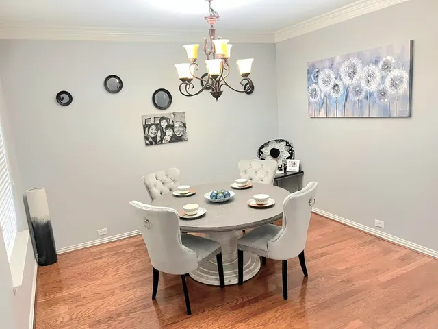 a view of a dining room with furniture wooden floor and a chandelier