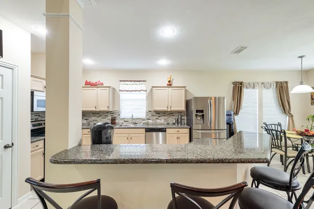 a kitchen with counter top space cabinets and appliances