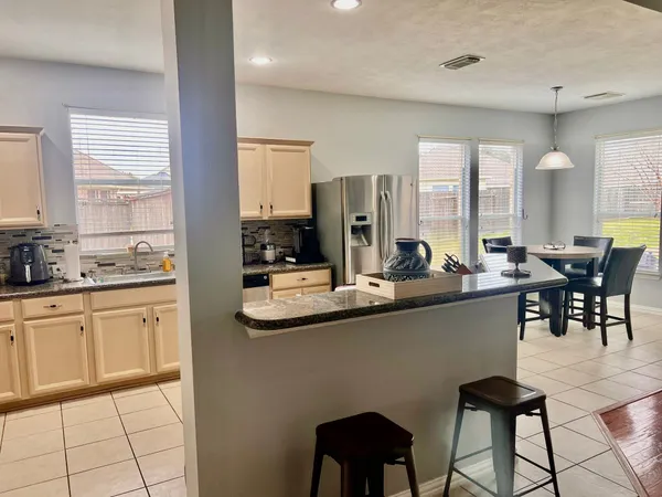 a kitchen with stainless steel appliances kitchen island granite countertop a sink and cabinets