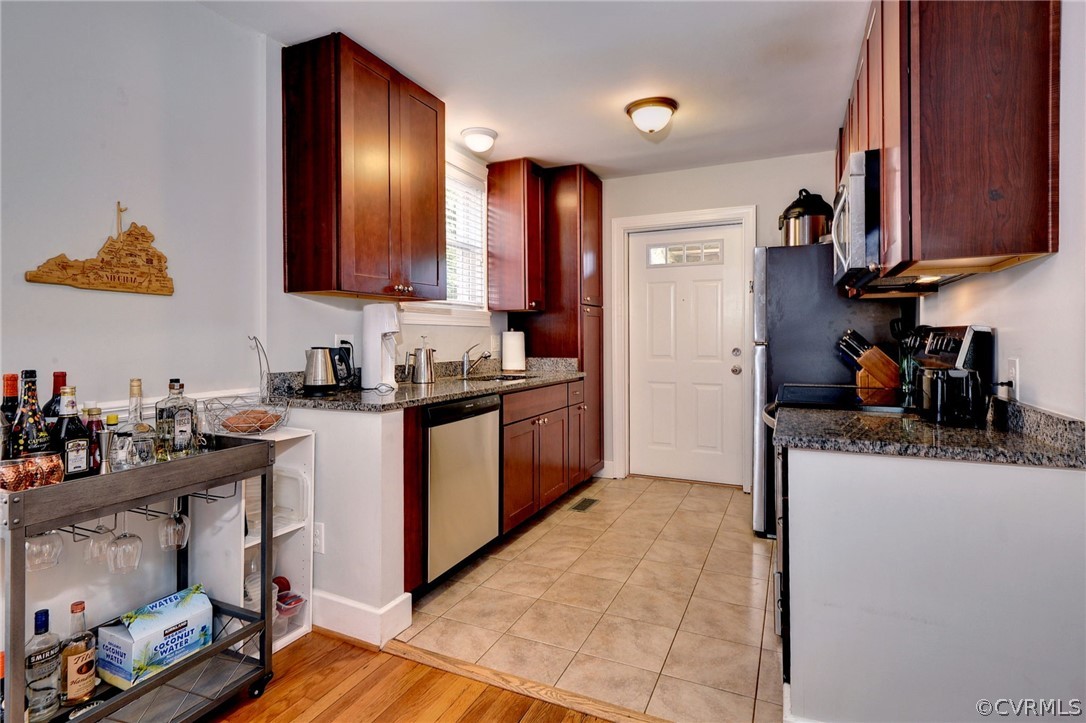 905 Lake Road Richmond, VA 23220 - Photo 13 of 50 a kitchen with stainless steel appliances granite countertop a sink stove and cabinets