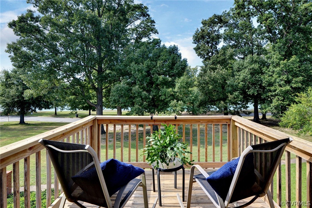 905 Lake Road Richmond, VA 23220 - Photo 27 of 50 a roof deck with chairs and wooden fence