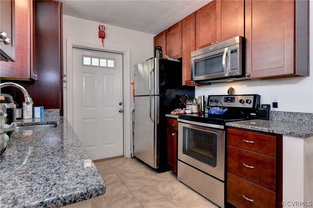 905 Lake Road Richmond, VA 23220 - Photo 36 of 50 a kitchen with stainless steel appliances granite countertop a stove microwave and sink