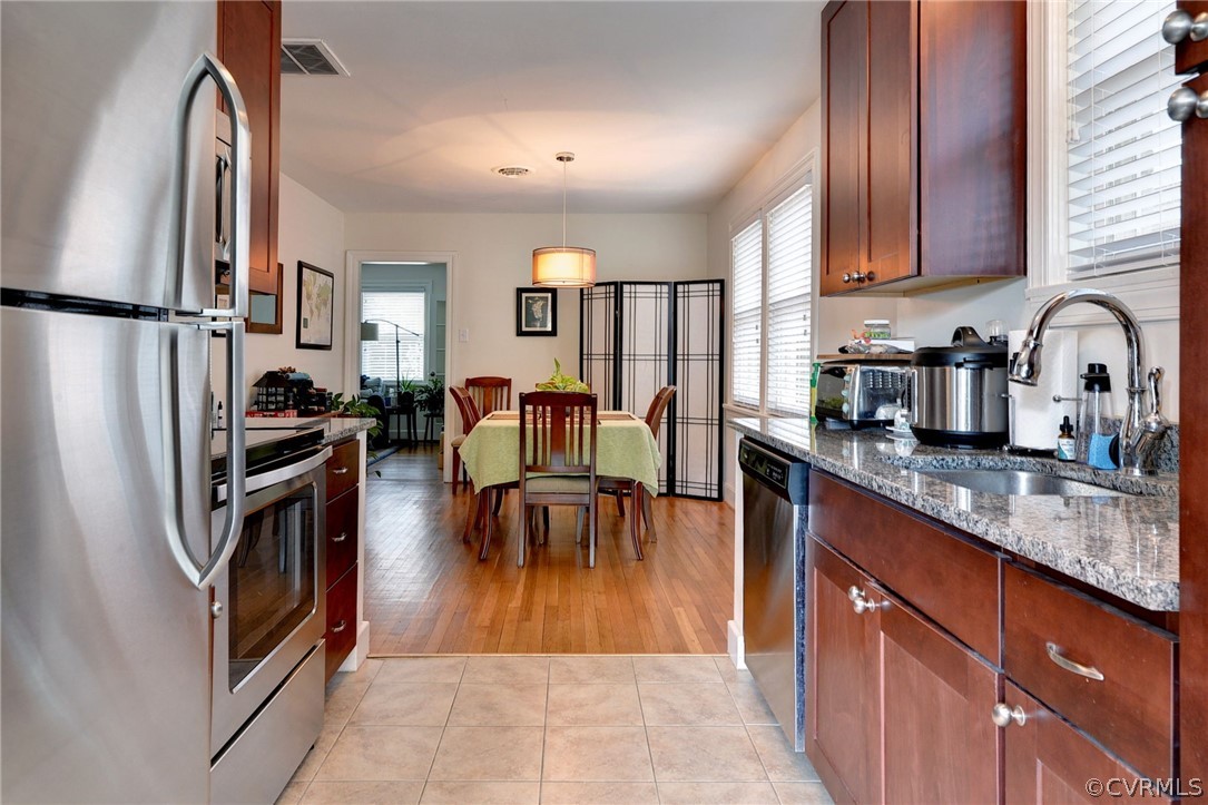 905 Lake Road Richmond, VA 23220 - Photo 37 of 50 a kitchen with stainless steel appliances granite countertop a refrigerator sink and cabinets
