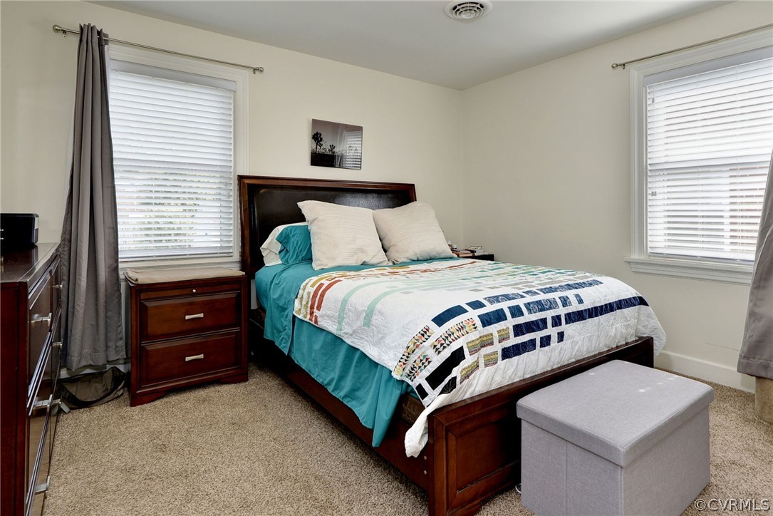 905 Lake Road Richmond, VA 23220 - Photo 38 of 50 a bedroom with a bed and a dresser next to a window