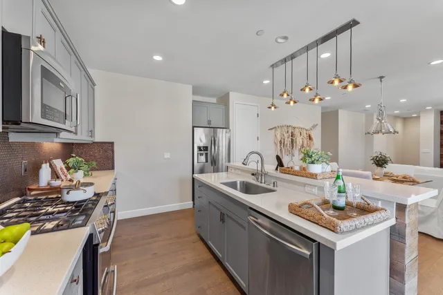a kitchen with a sink stove and cabinets