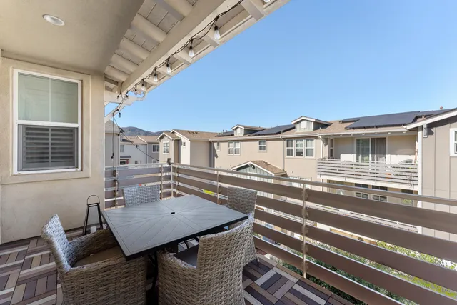 a balcony view with a seating space