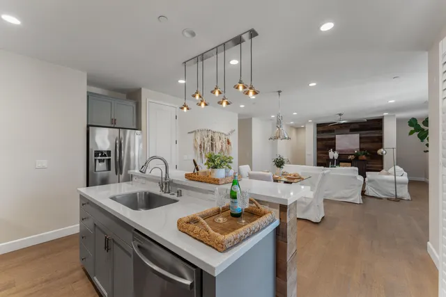 a kitchen with stainless steel appliances a sink stove and refrigerator