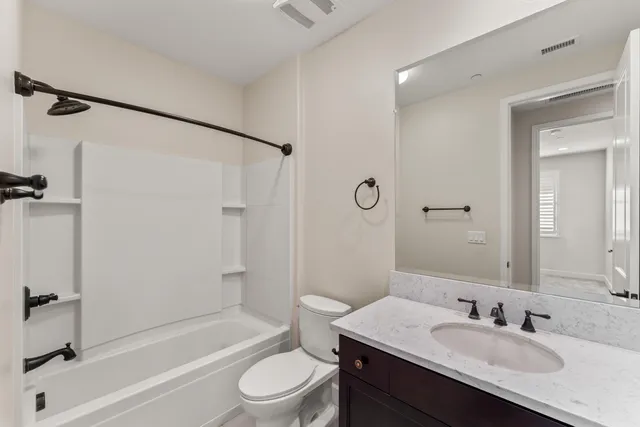a bathroom with a shower sink and mirror