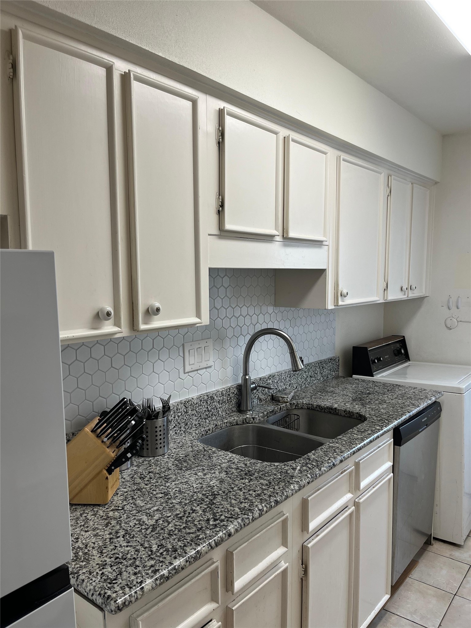 515 Tallowood Road, Unit 55 Houston, TX 77024 - Photo 9 of 18 a kitchen with stainless steel appliances granite countertop a sink stove and cabinets