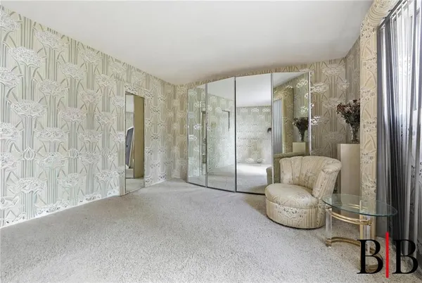 a living room with furniture and a shower