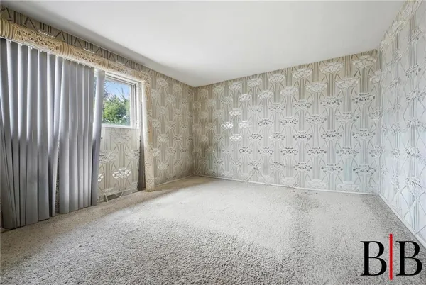 a view of an empty room with a window