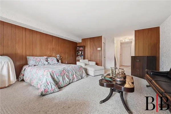 a spacious bedroom with two beds and a couch