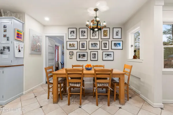 a view of a dining room with furniture and chandelier