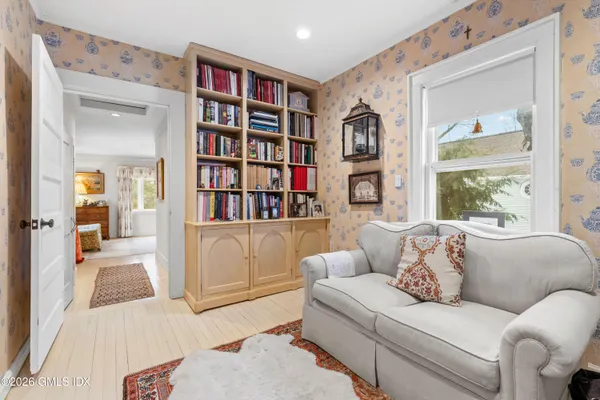 a living room with furniture and a book shelf